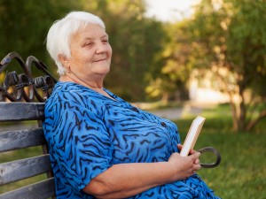 smiling woman on a park bench